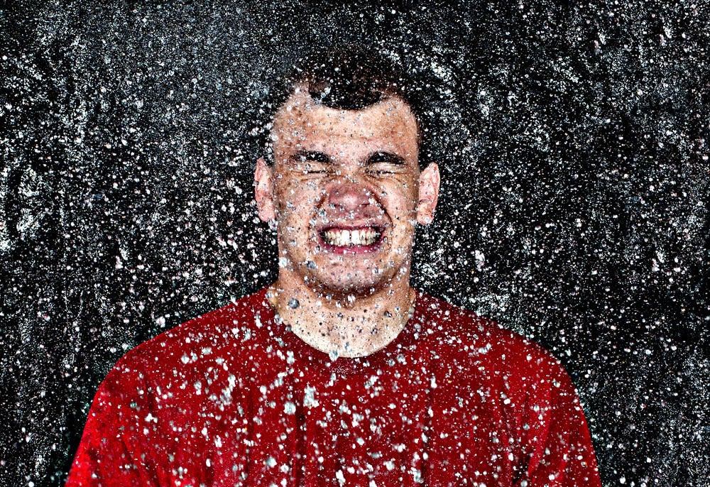 man splashed with suspended water droplets