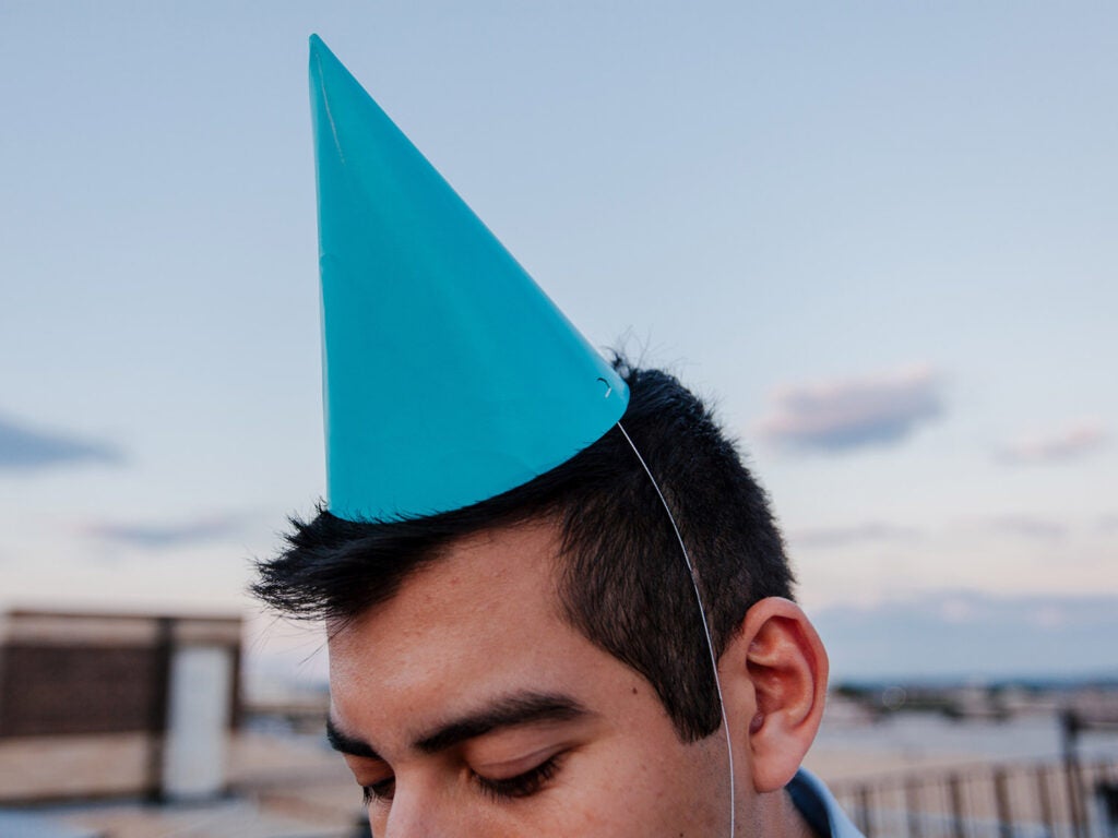 man with a blue party hat