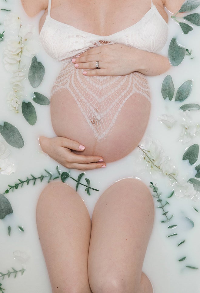 pregnant woman in a floral milk bath