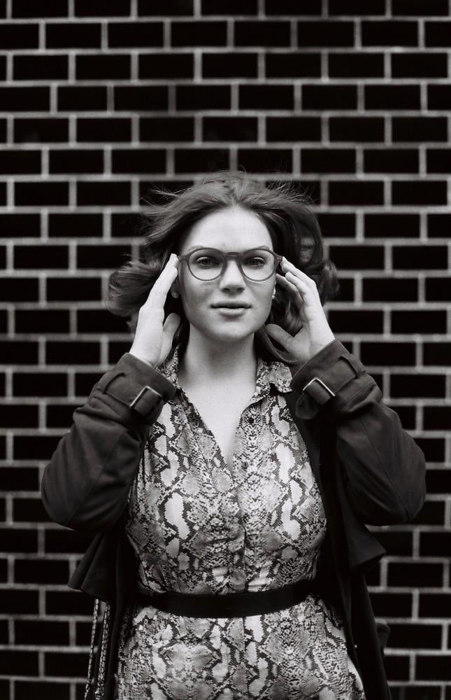 black and white photo of model with glasses