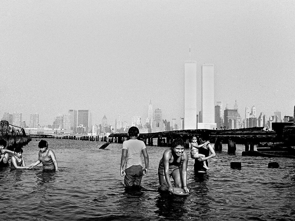 children playing in water near twin towers