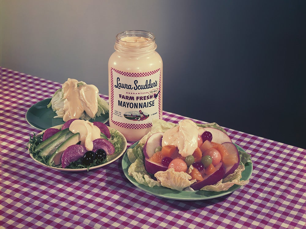 Salad topped with mayonnaise with mayonnaise bottle