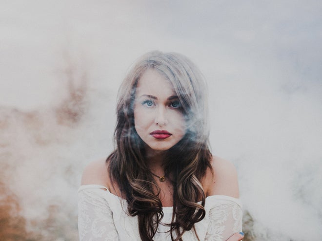 Beautiful woman shrouded in smoke