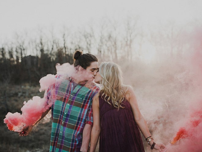 newly engaged couple kissing in smoke