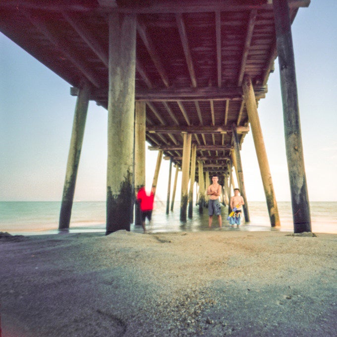 sample photo of boys under a beach pier