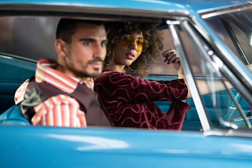 man and woman posing in blue vintage car