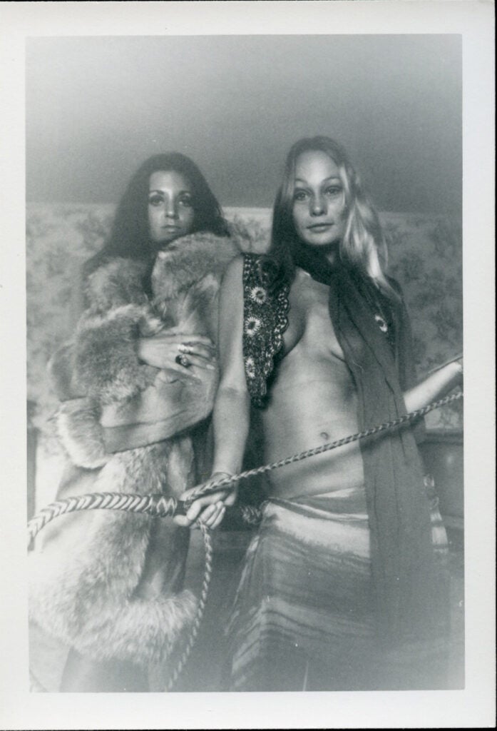 women in fur holding rope