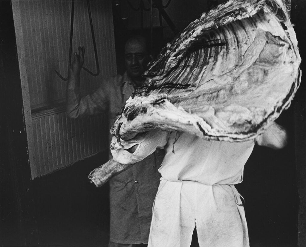 Untitled [Tom Roddy carrying a carcass of beef], 1968-70. From the series 