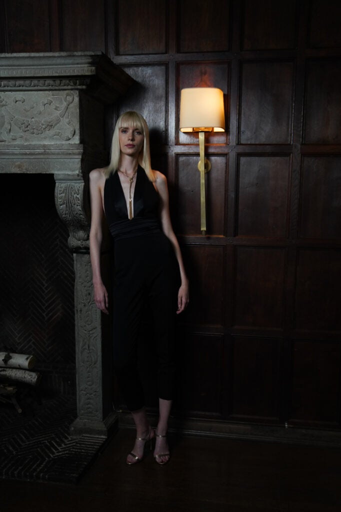 blonde woman in black dress in dim light