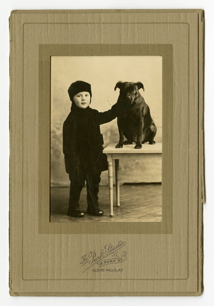 vintage photo of child in cap with dog