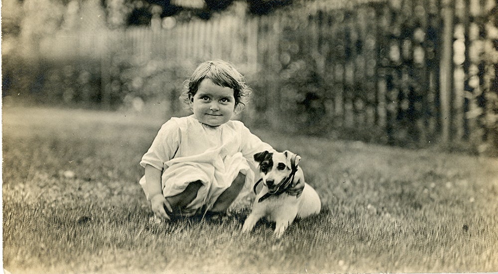 Vintage photo of small girl and her puppy