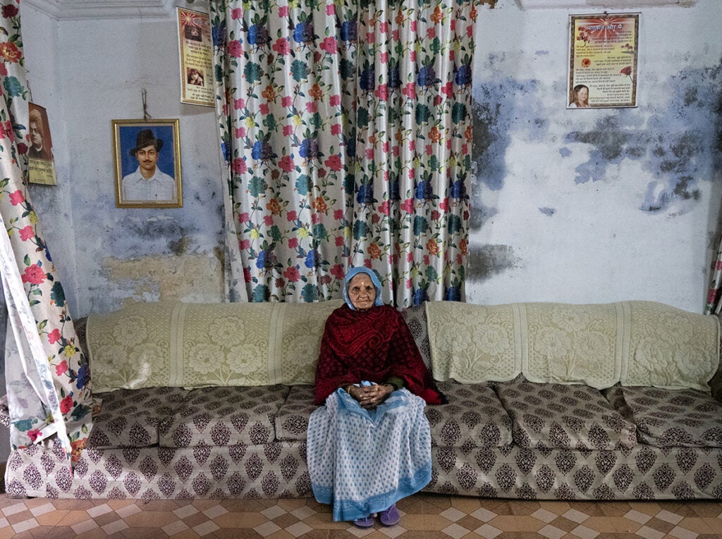 A widow sitting in the couch in Durga Kund Help Line ashram