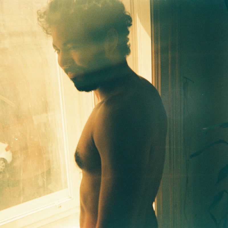 shirtless man by the window