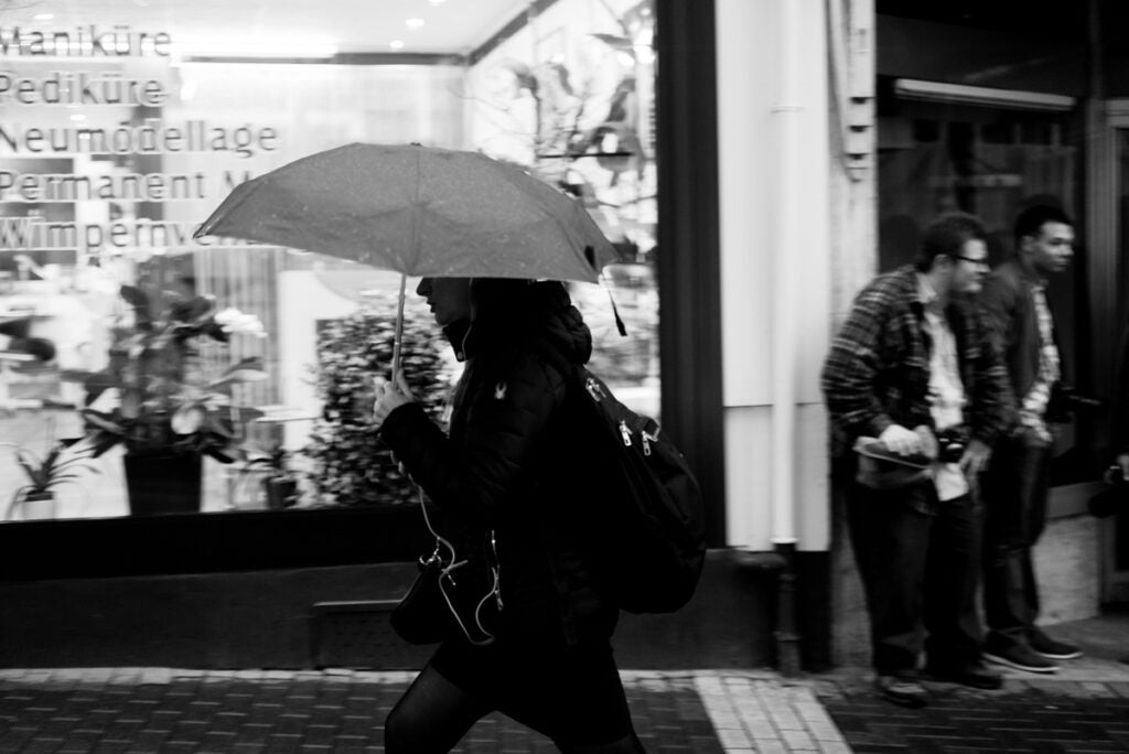 black and white pedestrian with umbrella