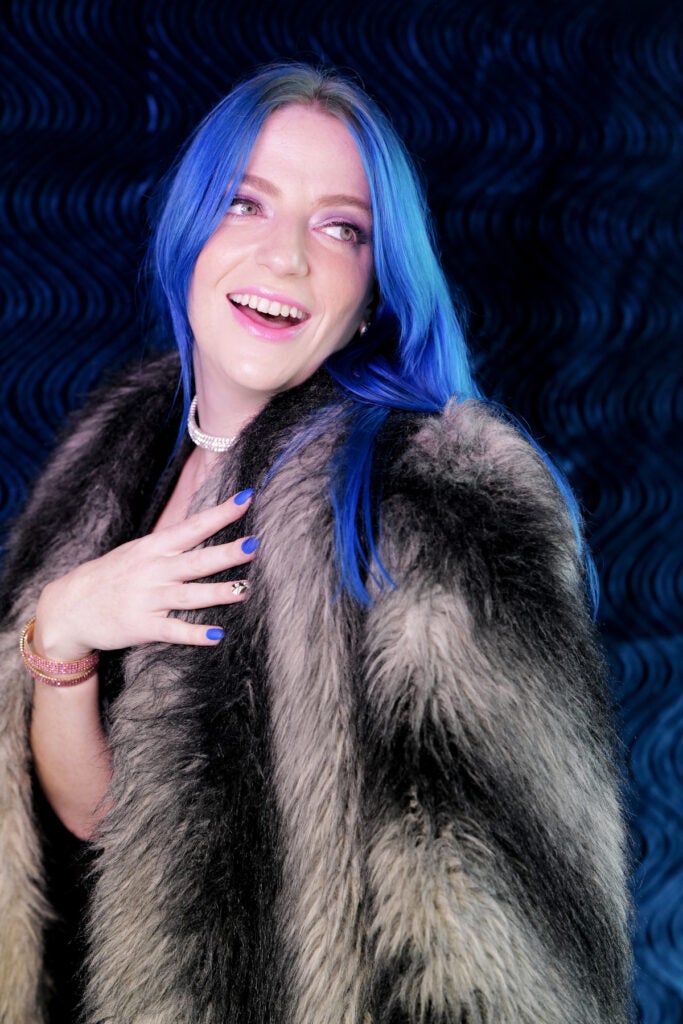 woman in fur coat with blue hair