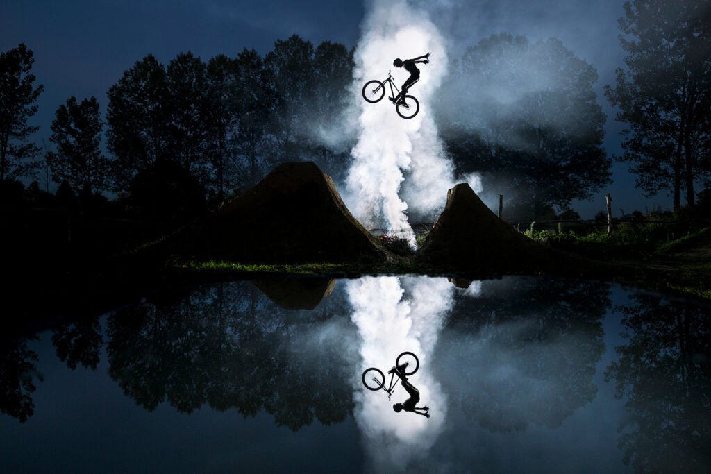 mirrored shot of Jeremy Berthier jumping on bicycle
