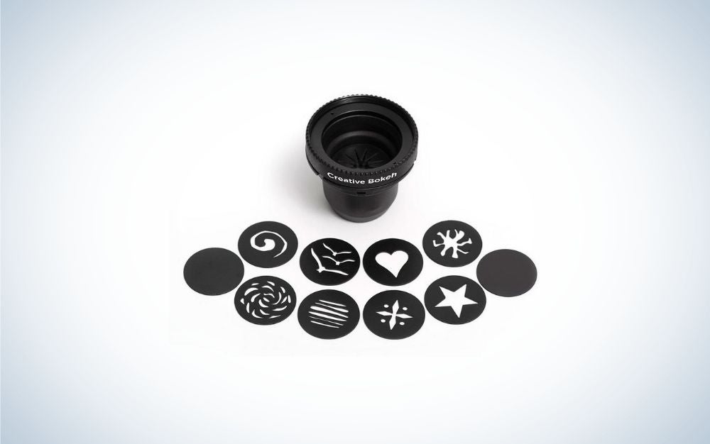 A black rounded Lens Bokeh Optic with different creative forms in front of it.