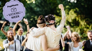 Young lesbian couple celebrating their marriage in front of their friends. The wedding ceremony is outdoors