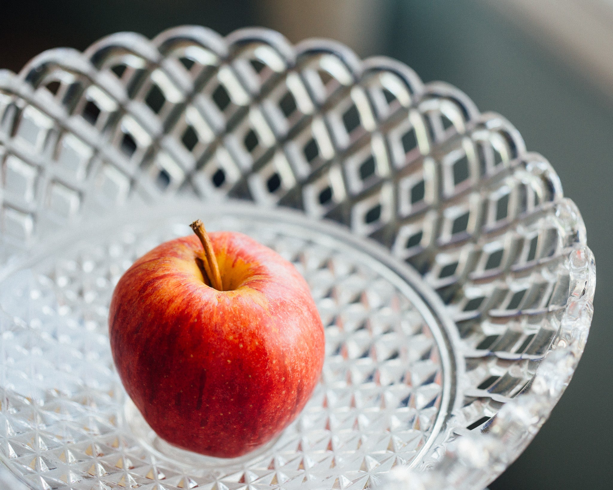 a fruit bowl with an apple in it.