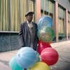 man with colorful balloons