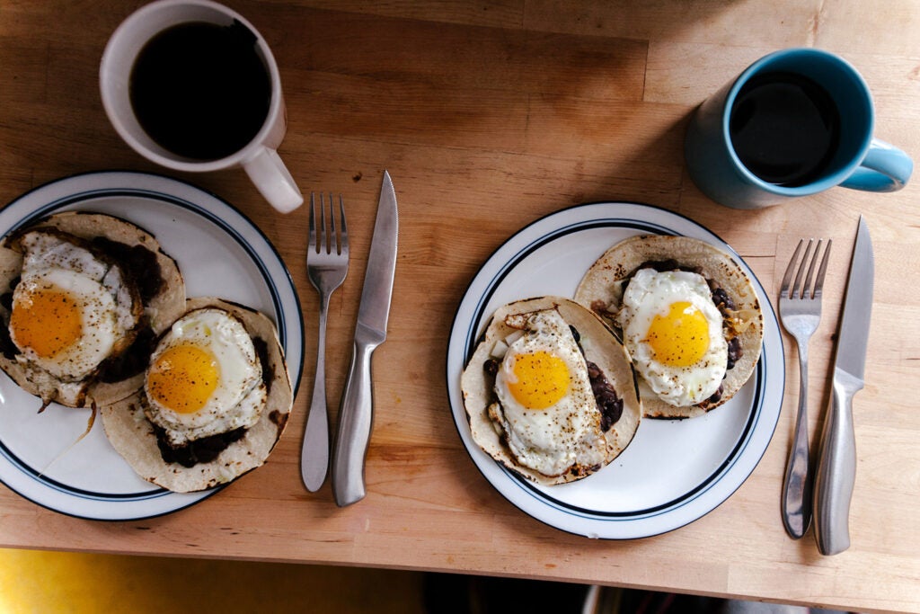 two plates of eggs and coffees