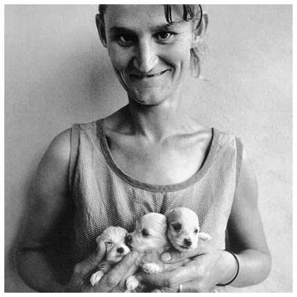 Wife-of-abattoir-worker-holding-three-puppies-Ora