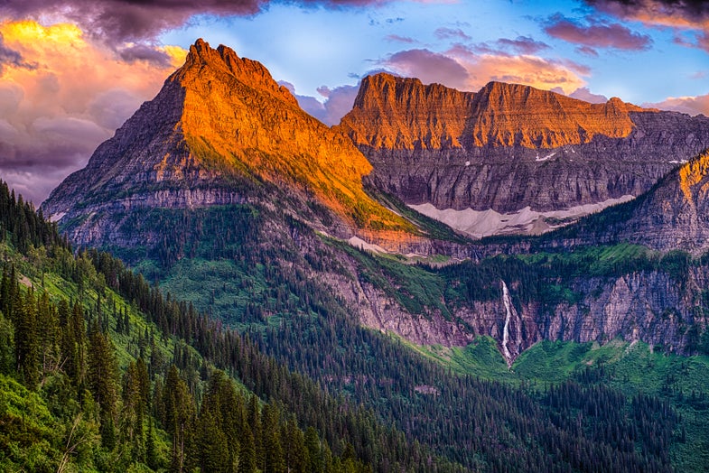 The setting sun lights up peaks along the Going to the Sun Road in Glacier National Park in Montana.