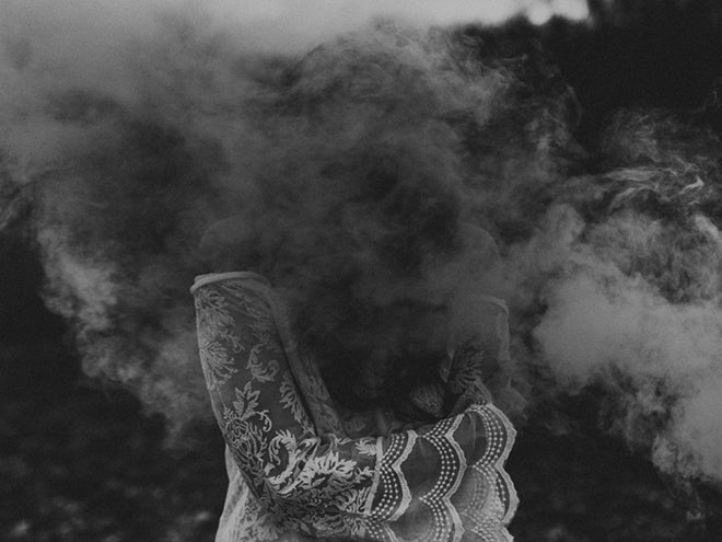 woman hidden by smoke