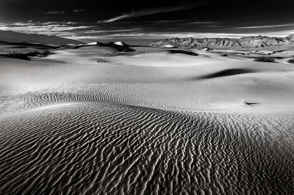 Photo: Lara Matthews I hiked through sinking sand, stopping to look around for areas where shadowed gradients met the light. When I arrived at this location, no one was in sight. I sat for hours by my tripod, emptying my mind and breathing in the soft desert air. Shadows crept across the barren landscape and long lines raced across the desert floor. Golden rays shined on the sand, highlighting its beauty and form. The sun kissed the sand one final time before falling out of the sky. I photographed in silence. CAMERA: Canon EOS 6D FOCAL LENGTH: 20mm SHUTTER SPEED: 1/15 sec LENS: Sigma 20mm ISO: 100 APERTURE (F-STOP): f/20