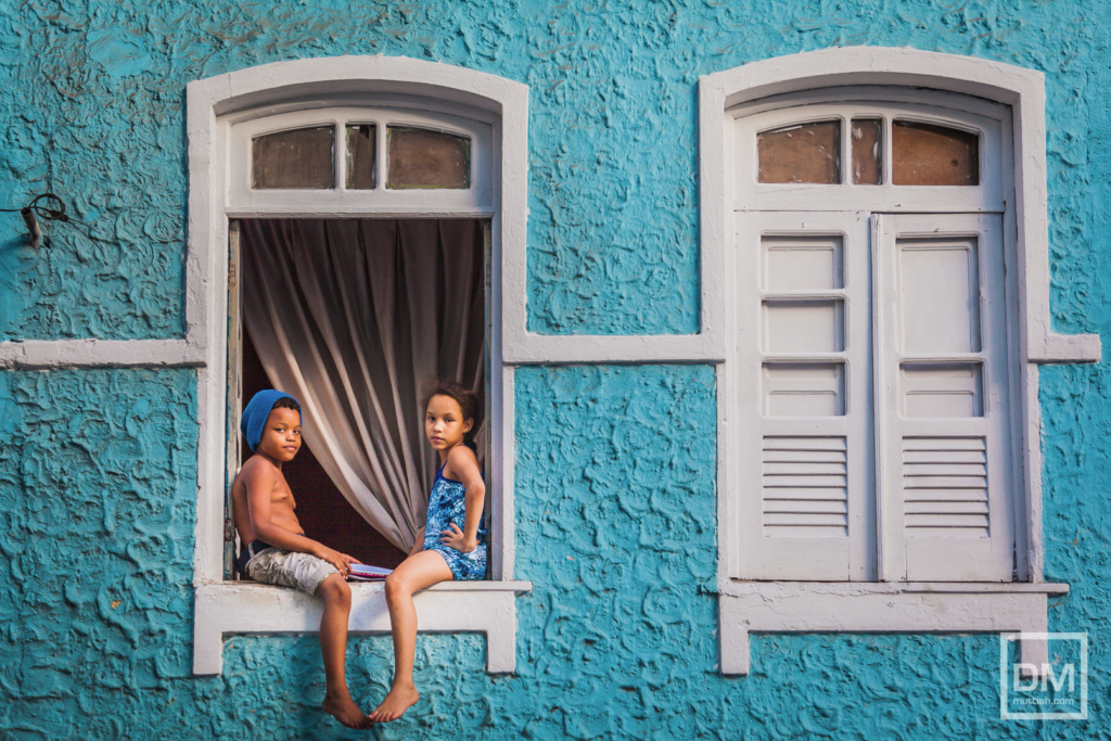 Today's Photo of the Day comes from Davo Muttiah and was taken in Salvador, Brazil with a Canon EOS 5D Mark II and a EF 24-105mm f/4L IS USM lens at 1/400 sec, f/4 and ISO 200. "I was photographing the homes around a neighborhood in Salvador. Then I noticed these two kids sitting out the window," Muttiah writes regarding the image. "Made for a perfect photo." See more work <a href="https://www.flickr.com/photos/muttiah/">here.</a>