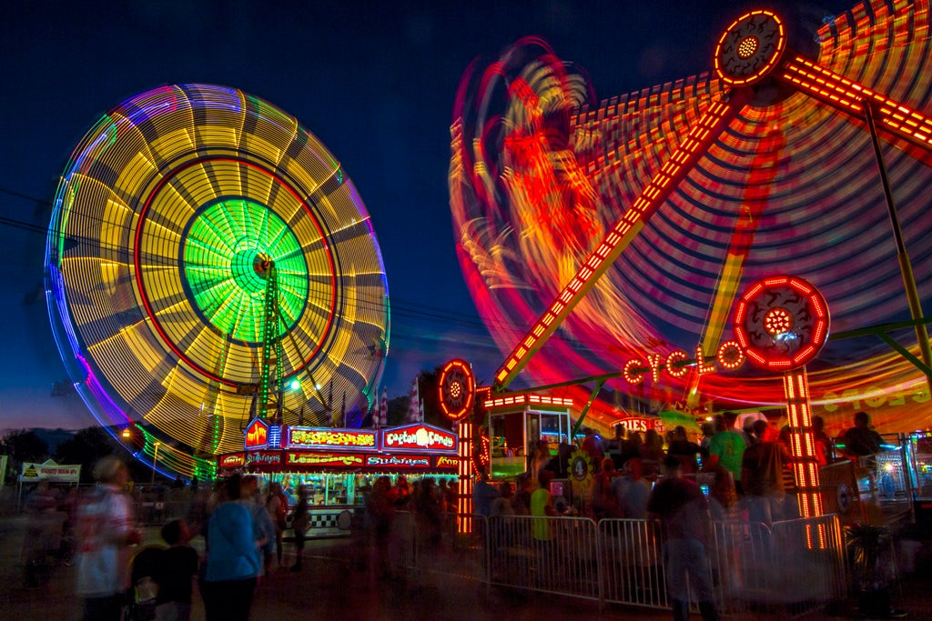 Today's Photo of the Day was captured by Mark Chandler at the North Georgia State Fair in Marietta, Georgia. Chandler used a Canon EOS 7D
with a wide 11-16mm lens, a long 13 second exposure at f/22 and ISO 100 to capture these carnival rides in motion. See more work <a href="https://www.flickr.com/photos/10smark/">here. </a>