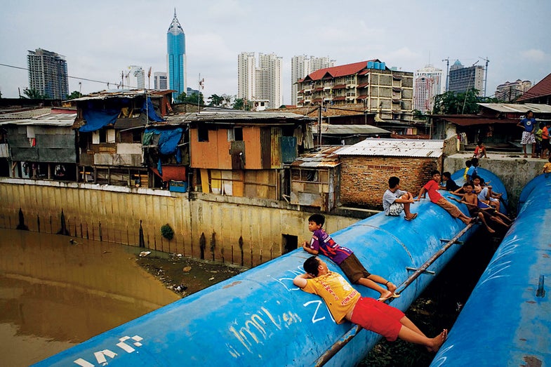 Children playing on water mains in Jakarta, Indonesia