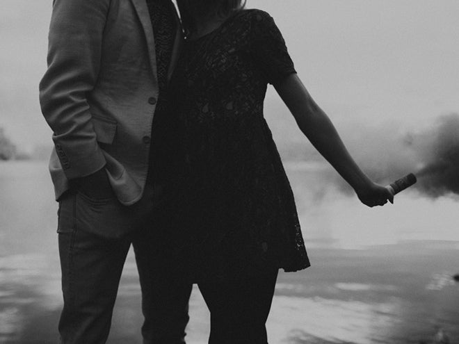 Couple holding smoke bombs