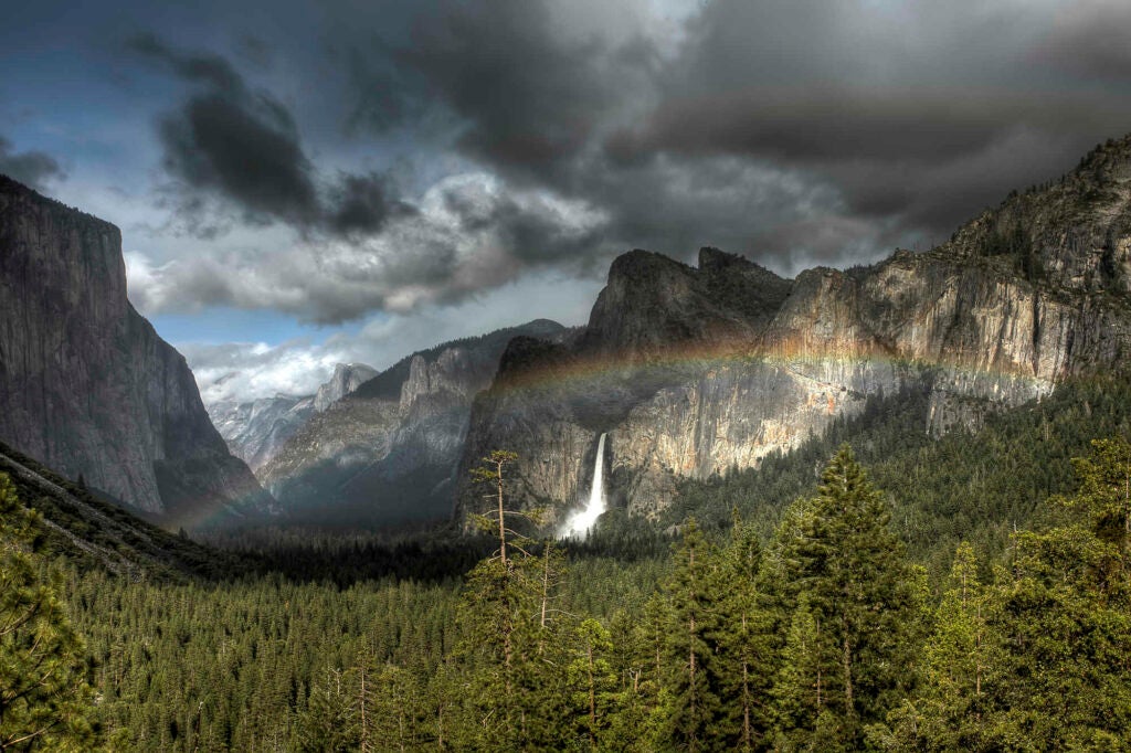 Forming of a double rainbow over the Yosemite Valley at the Wawona Tunnel overlook.