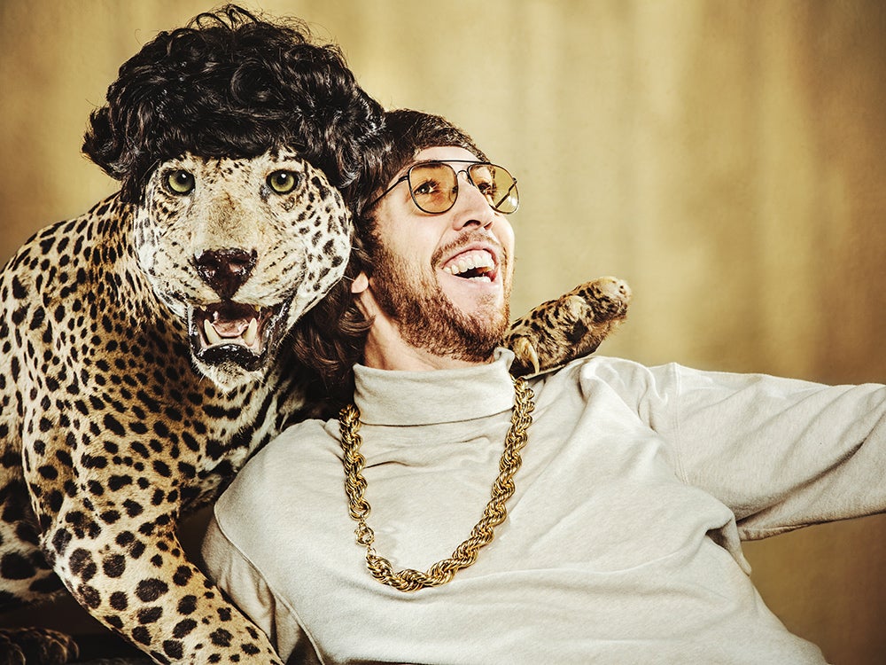 Retro Man Poses with Wig Wearing Leopard