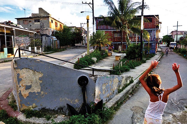 “This joyfully playing girl is just the kind of reward that Cuba offers photog­raphers who have the patience to wait for it,” says Sven Creutzmann. He photographed the scene below in Havana’s Playa district in 2013.