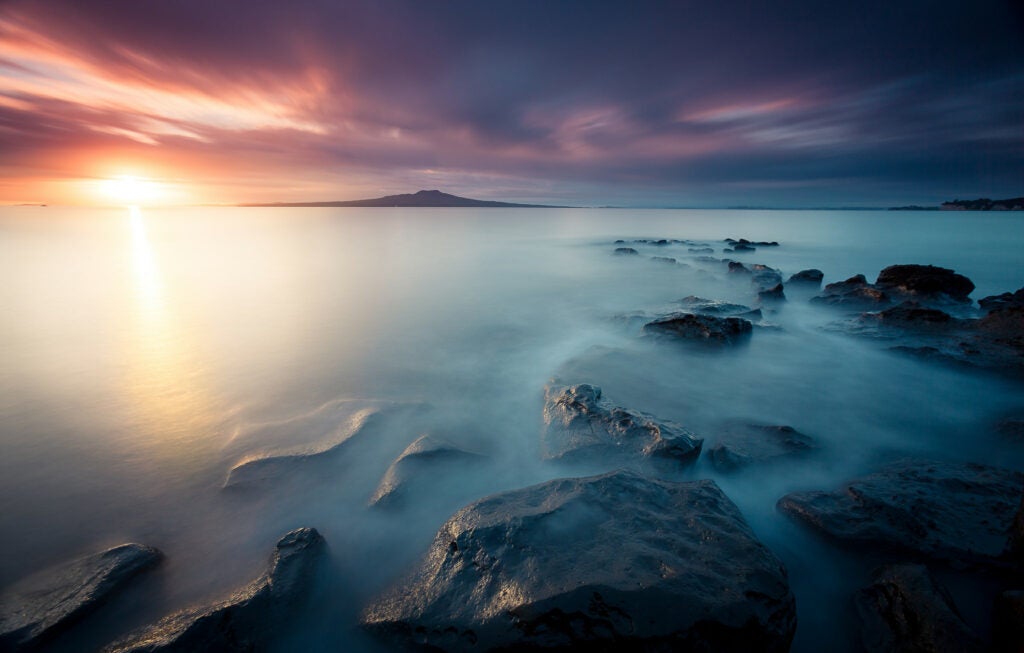 Today's Photo of the Day was captured by Sid Bhateja in Takapuna, New Zealand at sunrise. To capture these beautiful colors and smooth looking water Bhateja used a Canon EOS 5D Mark II
EF with a 16-35mm f/2.8L USM lens with a three stop ND filter, a long two minute exposure at f/8 and ISO 100. See more work <a href="https://www.flickr.com/photos/123475341@N08/">here. </a>