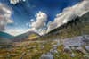 The puffy white clouds contrasted brilliantly with the deep blue sky, and the rocky mountains - this was clicked on a trekking trip to Laka Glacier in India.