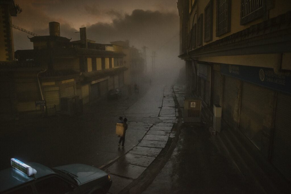 Realizing this old town (Laocheng, means old town in Chinese) would soon be transformed into a new town through the speedy economic growth in China and perhaps lose its raw beauty in no tome, I was pleased to capture this working mother carrying her child in her basket walking through the thick mist in a very early foggy morning, 2012.