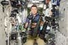 Russian Astronaut Poses With Floating Nikon Cameras on the International Space Station