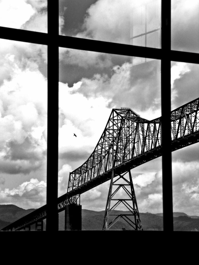 The Astoria-Megler Bridge crossing the Columbia viewed from a window on a pier.