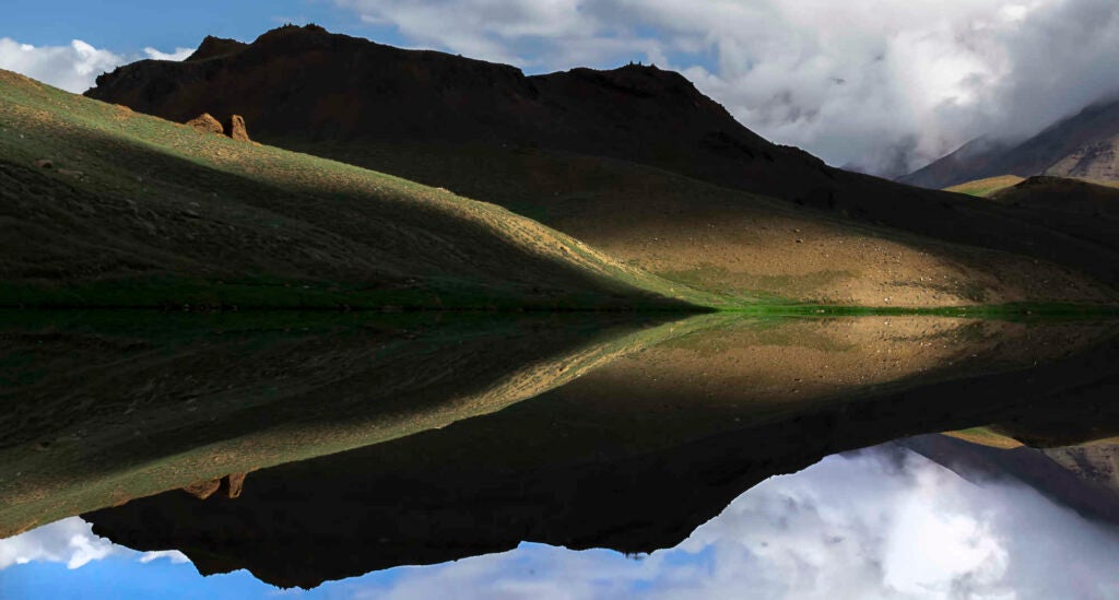 It's impossible to identify if the reflection is fake or real but this is all real, brilliant play of lights and shadow on one of the most beautiful lake I've ever seen.. Chandrataal also known as moon of the lake.