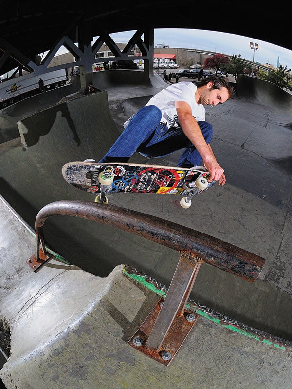 Rocco performing on a new bar prop in the park on skateboard