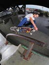 Rocco performing on a new bar prop in the park on skateboard