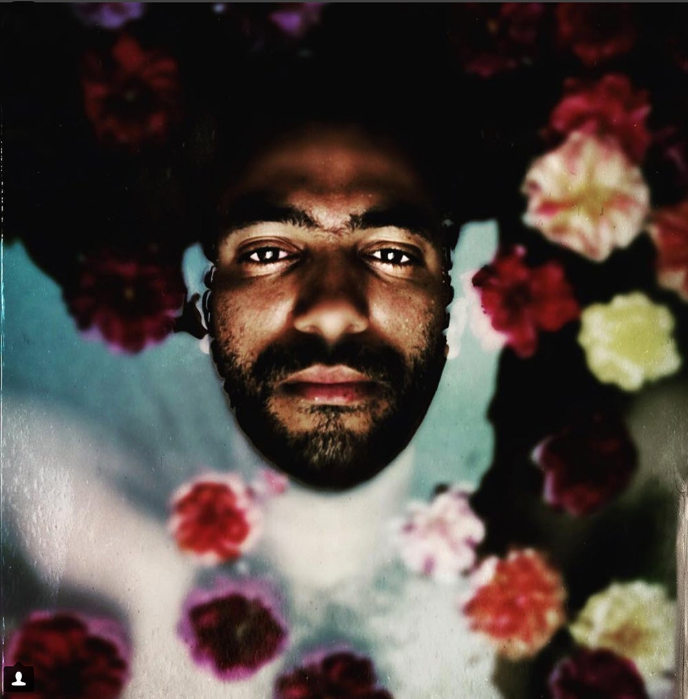 mans face among flowers