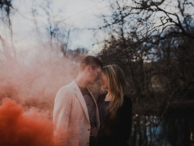 Loving couple in orange smoke