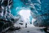 One Of The Most Amazing Places I Visited In Iceland Was This Ice Cave In The Vatnajökull Glacier National Park. This Park Is Home To One Of The Largest Ice Caps In Europe And The Largest In Iceland, Covering About 8% Of The Country. The Amazing Blue Color Of The Ice Is Created By The Increased Density Of The Glacial Ice. The Oxygen And Hydrogen Rich Ice Absorbs Most Of The Visible Color, But Reflects Back The Blues That You See In Here. This Is Quite A Stunning And Awe Inspiring Sight. My First Attempt At Capturing A Photo Of The Cave Was Without Anyone In The Frame, But I Quickly Realized That There Was A Complete Lack Of Scale. As I Was The Only One Standing Around I Needed To Figure Out How To Get Myself Into The Photo To Show Just How Big This Cave Really Was. I Also Had To Compensate For The Harsh Lighting Coming Through The Entrance Of The Cave. I Set My Camera For A 5 Exposure Bracket, Focused On A Point On The Ground Around Where I Would Stand And Set The Timer. I Then Quickly Ran Into Place And Stood Still While My Camera Took The 5 Shots.