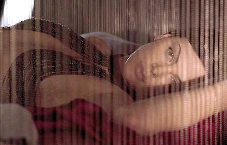 "Charlize-Theron-is-photographed-in-the-bedroom-set"
