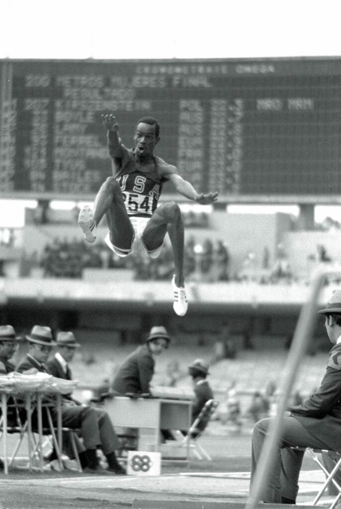 Bob Beamon of the United States leaps 29 feet, 2½ inches, 8.90m to win gold and set an Olympic record during the Men's Long Jump event at the XIX Summer Olympics on 18th October 1968 at the National Stadium in Mexico City, Mexico. Show less