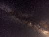 Meteors crossing the night sky past the Milky Way